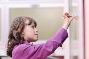 happy school girl on math classes finding solution and solving problems
