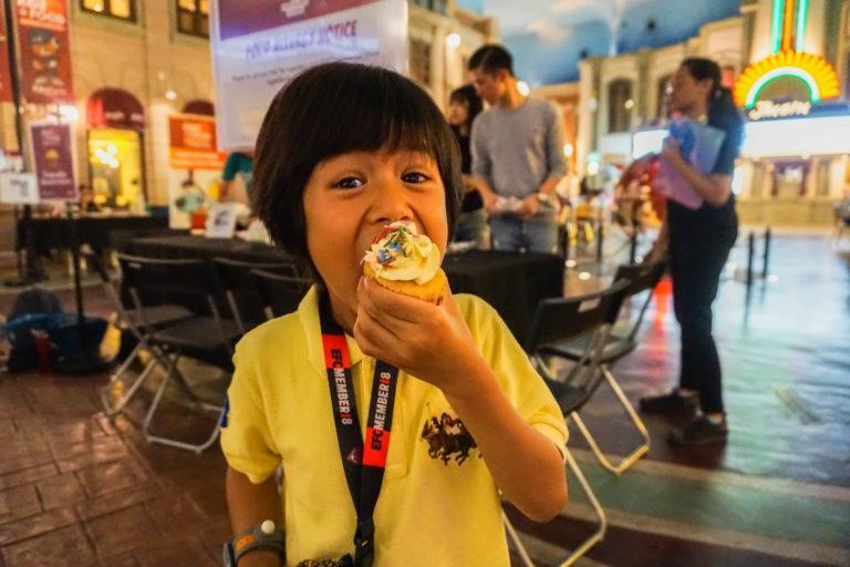 Child at KidZania enjoying her cupcake