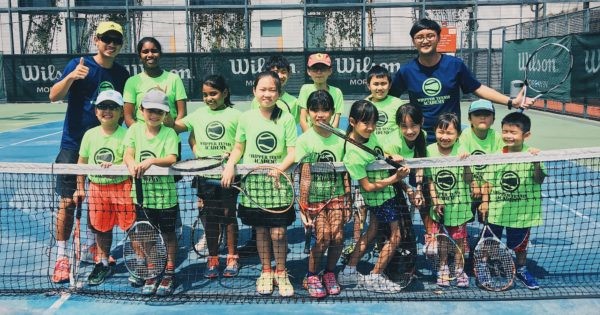 Students on a tennis court for a Whipper Tennis class