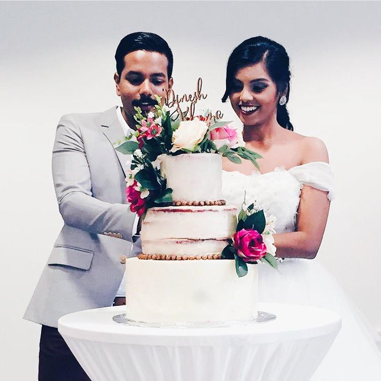 Wedding couple cutting into Matthew Shia's ombre wedding cake